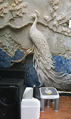 Hand-carved peacock mural on the studio wall